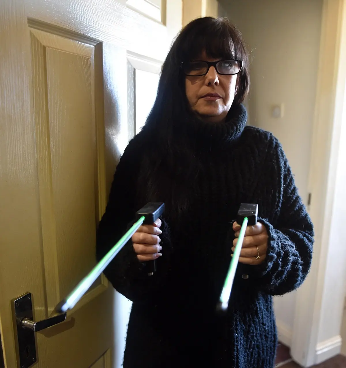 Kelly Woodcock holding a pair of dowsing rods