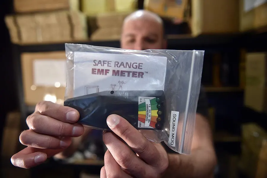 Sam Ashford holding up our K2 EMF meter