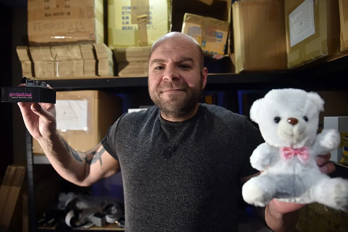 Sam holding a touch activated teddy bear and the PMB
