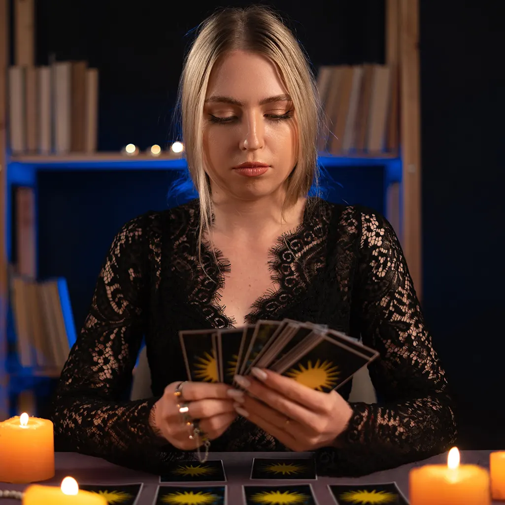 A lady shuffling a deck of tarot cards
