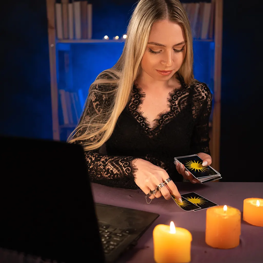 A woman carrying out a psychic medium reading online with her laptop